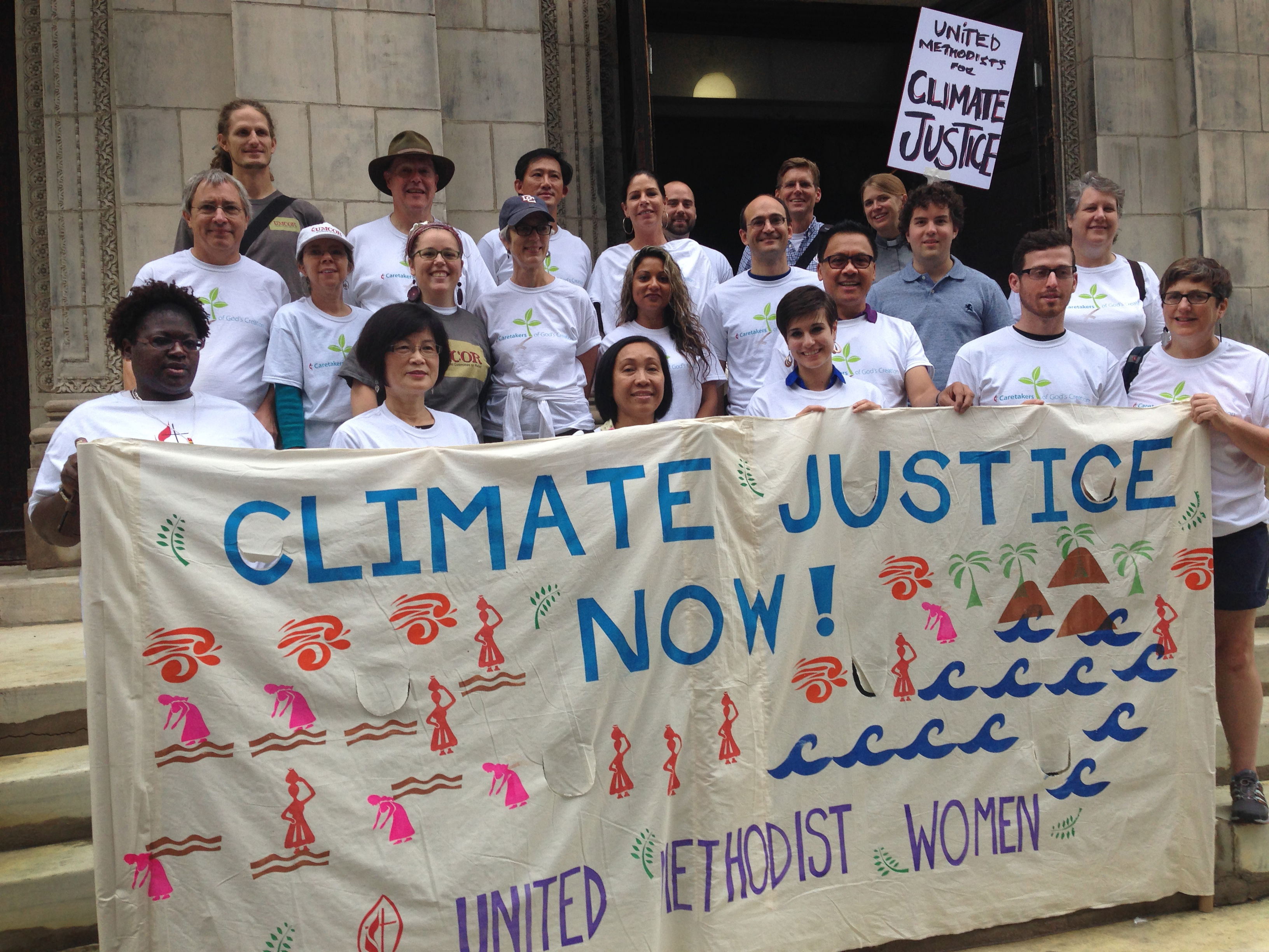 One group of United Methodists participating in the People's Climate March on Sept. 21, 2014, in New York gather on the steps of the United Methodist Church of Saint Paul and Saint Andrew before heading south to join an interfaith gathering ahead of the march. 2014 file photo by Linda Bloom, UMNS