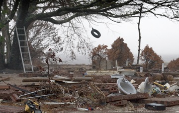 katrina-response-recovery-11 A tire swing sways in the wind from Hurricane Rita over the remains of a beachfront home destroyed by Hurricane Katrina in Ocean Springs, Miss. Rita made landfall in East Texas Sept. 24, 2005, nearly four weeks after Katrina hit Louisiana and Mississippi. Photo by Mike DuBose, UMNS.