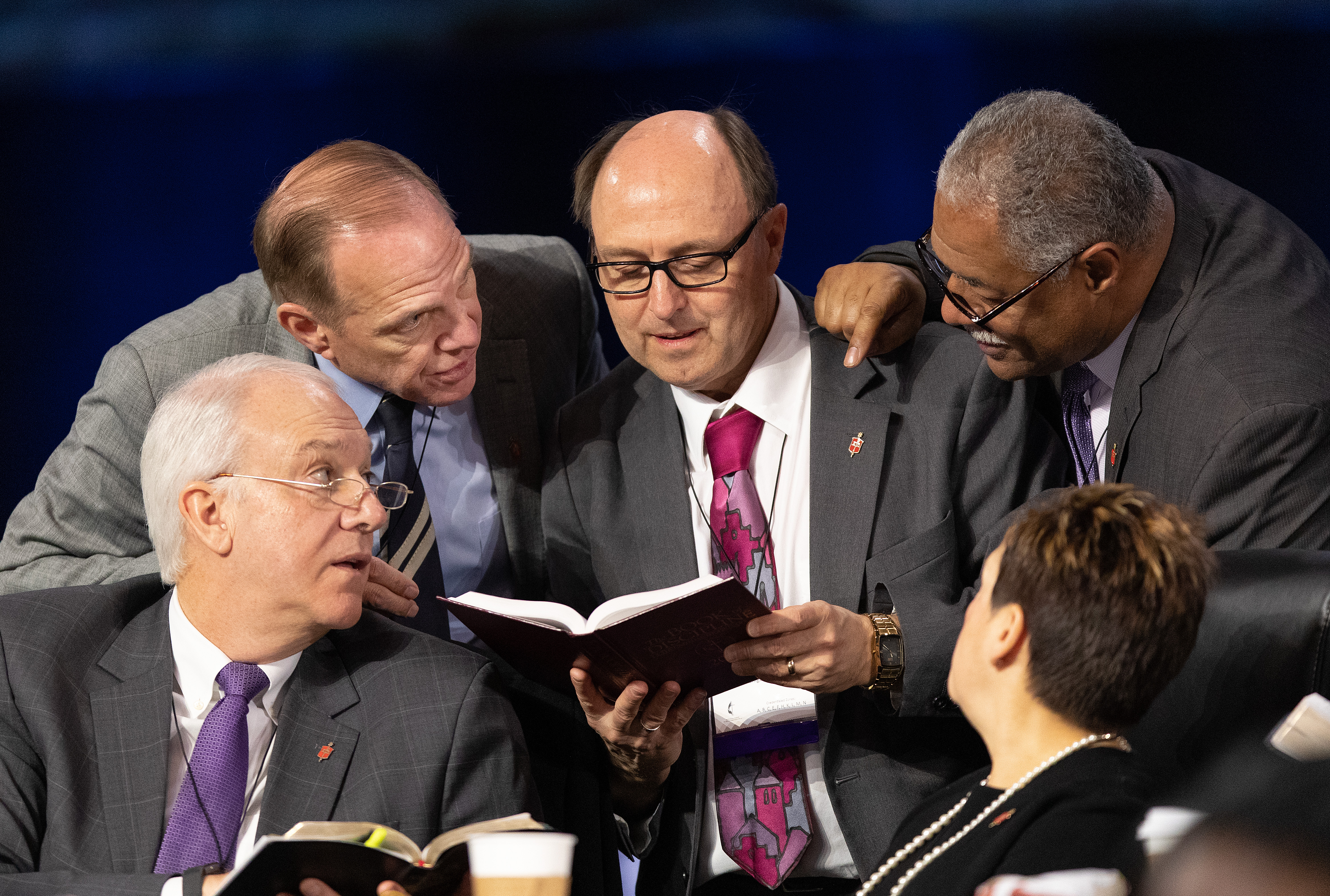 Bishops confer over the issue of whether the legislative committee can refer items to the denomination's Judicial Council for review during the 2019 United Methodist General Conference in St. Louis. Clockwise from lower left are Bishops Thomas Bickerton, John Schol, David Bard, Julius C. Trimble and Cynthia Fierro Harvey. Photo by Mike DuBose, UMNS.