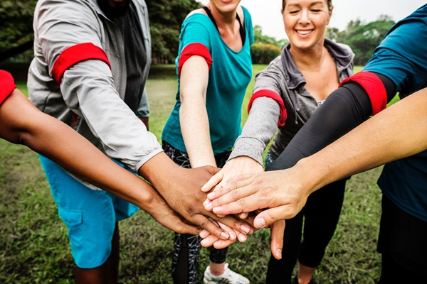 Women's hands form a circle. Image courtesy of pexels.com.
