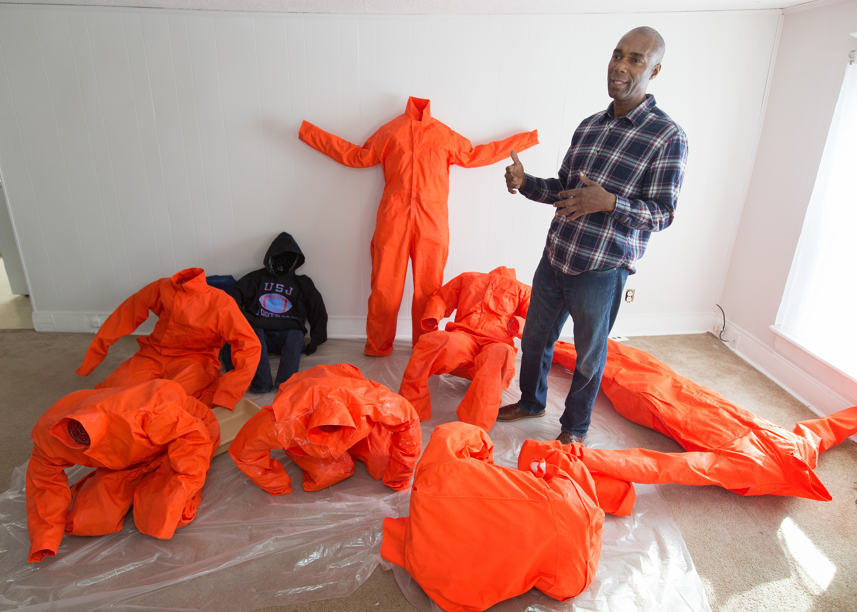 Ndume Olatushani, a death row exonoree, is one of the artists whose work is included in Stations of the Cross opening in Washington during Lent. Using chicken wire, Olatushani molds the jumpsuits into prisoners bowed and writhing in agony from being confined. Photo by Mike DuBose, UMNS.