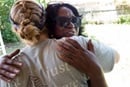Homeowner Betty Johnson hugs volunteer Jamie Jones who was part of a mission team from Santa Monica, Calif. Photo by Mike DuBose, UMNS.