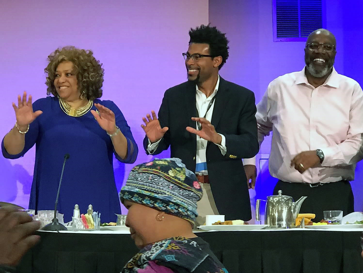 Deborah Dangerfield, president of the Black Methodists for Church Renewal (left), the Rev. Theon Johnson, associate pastor of Glide United Methodist Church (center), and the Rev. Anthony Jenkins, Western Jurisdiction BMCR chair, dance during the closing Gospel brunch at the BMCR 51st general meeting, March 17 in Sacramento, California. Photo by Mai Yang.