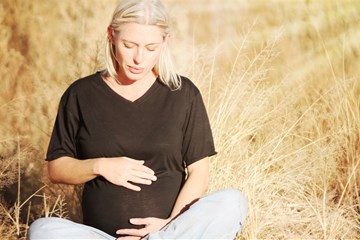 Photo illustration of pregnant woman in field. Courtesy of pexels.com/pixabay. 