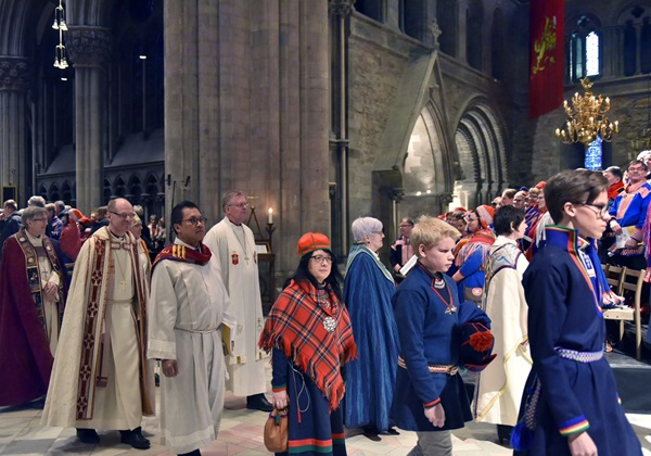 The Rev. Dr. Liberato C. Bautista, head of the U.N. and International Affairs office of the United Methodist Board of Church and Society, and Bishop Christian Alsted, episcopal leader for Northern Europe (third and fourth from left), walk in procession inside the National Cathedral in Trondheim. A service held in the Cathedral was part of the 100-year celebration of the first Sami Congress. Photo by Karl Anders Ellingsen.
