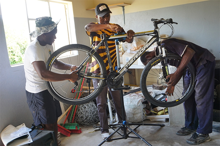 Gedion Mawoneke, Benjamin Dhliwayo and Damion Mutinhiri assemble a bicycle. United Methodist Church’s St. John’s Circuit in Mutare, Zimbabwe, is helping those in the Deaf community learn skills through the Holy Bike Sales project.