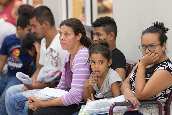 Immigrants who have just been released from a U.S. Border Patrol detention facility wait at the bus station in McAllen, Texas, in this photo from Aug. 1.