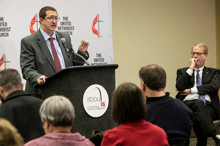 The Rev. Gary W. Graves, secretary of the General Conference, speaks to the press following the conclusion of the special session in St. Louis. To the right is Bishop Kenneth H. Carter. 