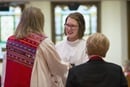A pastor recognizes members for their service to the community.