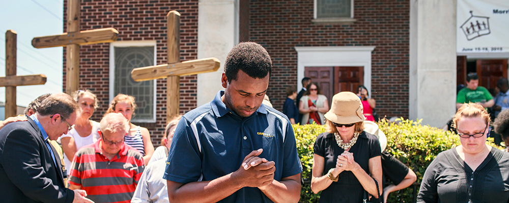 Robert Griggs (center) prays with others outside Morris Brown African Methodist Episcopal Church in Charleston, S.C. United Methodists joined AME members in prayers following the deadly shooting at Emanuel AME Church in Charleston. 
