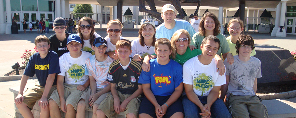 Stock photo of students and teachers sitting around fountain.