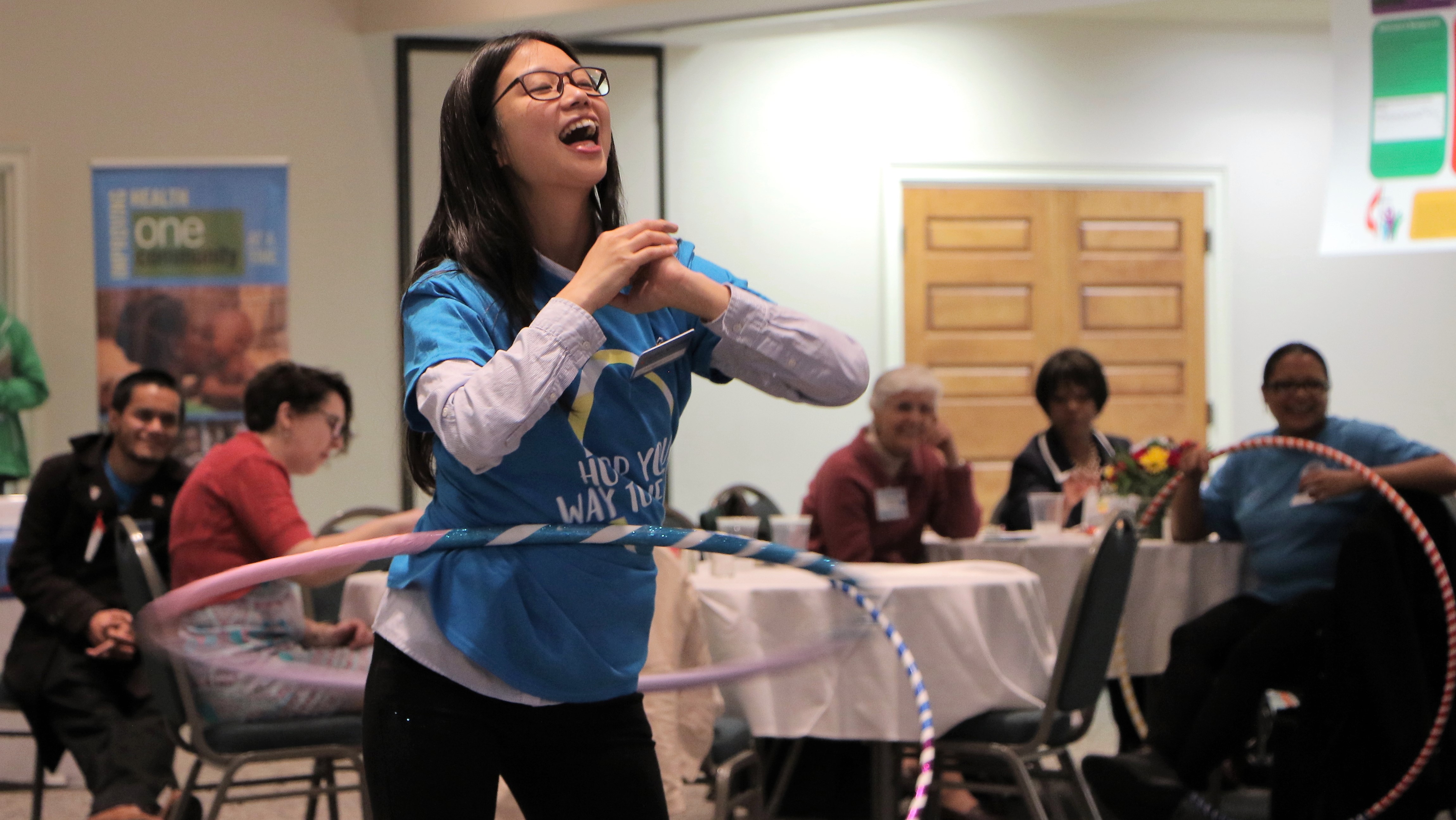 Using their hand-made hula-hoops, participants, including this young girl, join in on a friendly competition to see who could hula-hoop the longest. 