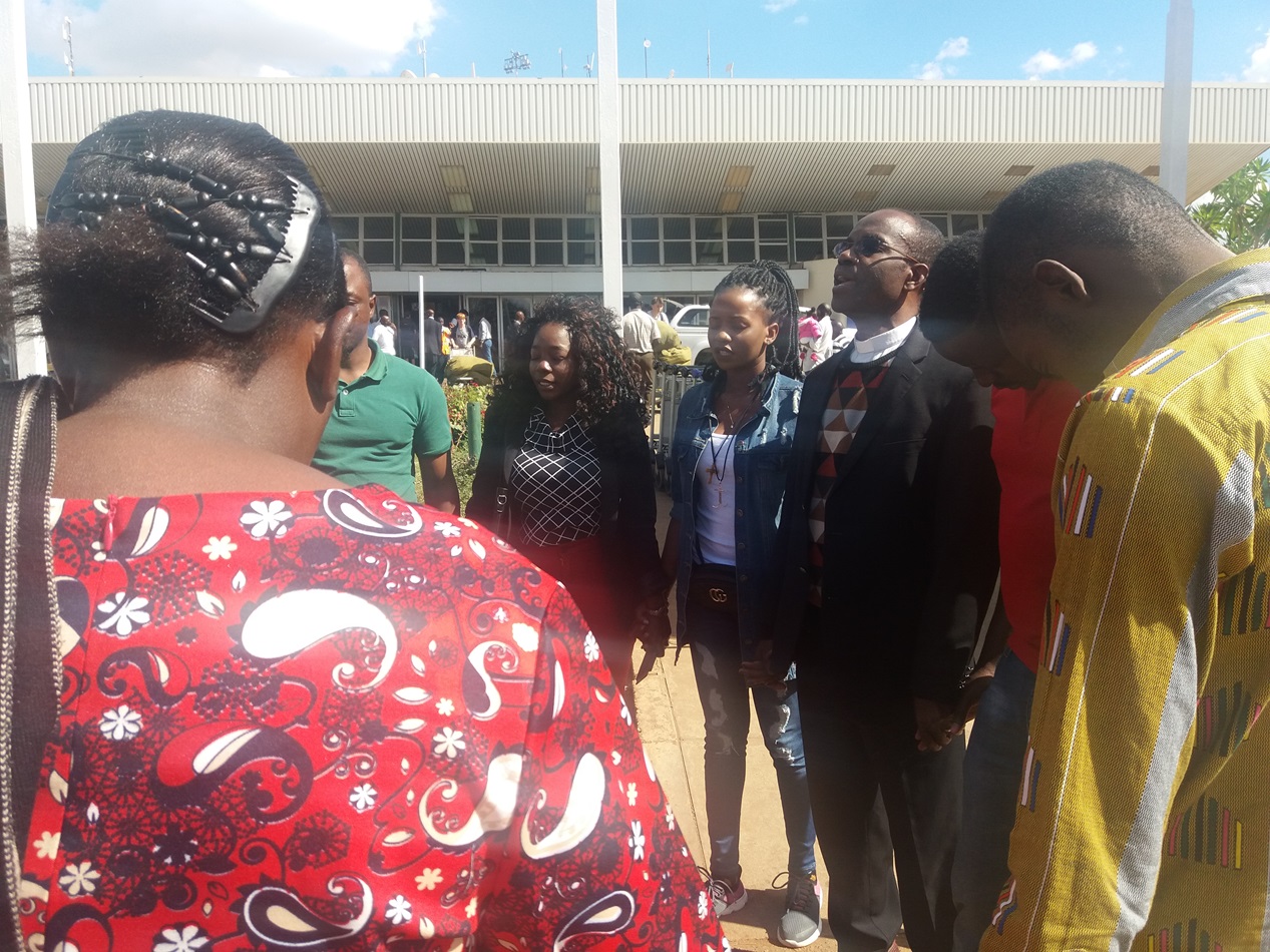 Malawian Miracle Osman and her supporters take time to pray to thank God for her safe return.