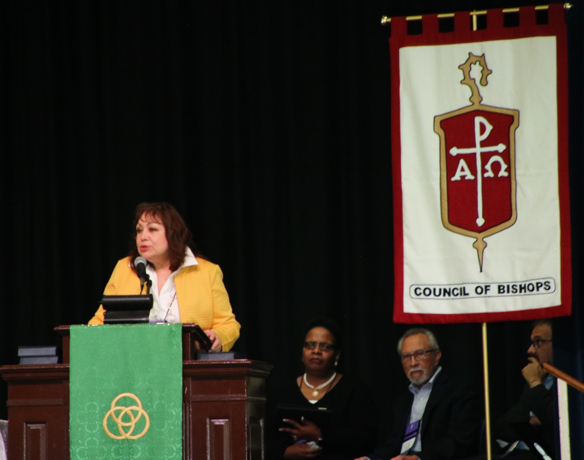 Bishop Minerva Carcaño, chair of the COB Immigration Task Force, presents the report and statement about immigration caravans during the plenary session at Epworth By the Sea on St. Simon's Island in Georgia. Photo by Maidstone Mulenga.