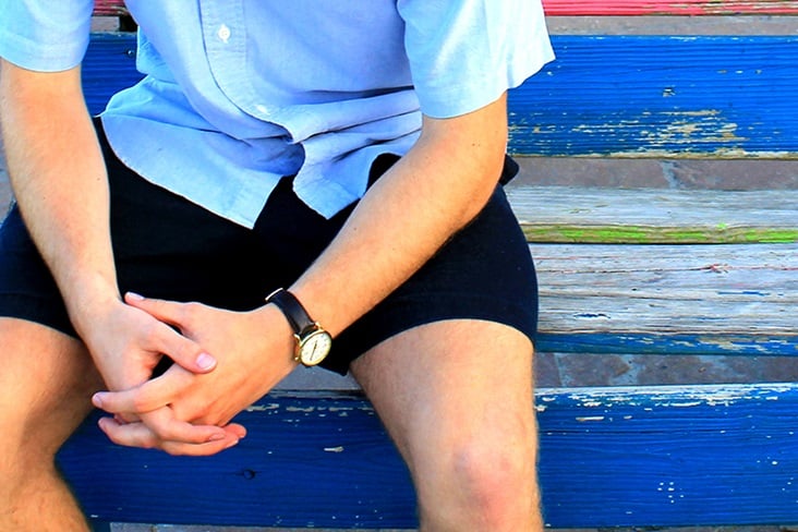 Man sits on bench with hands in prayer. Photo illustration by Kathryn Price, United Methodist Communications.