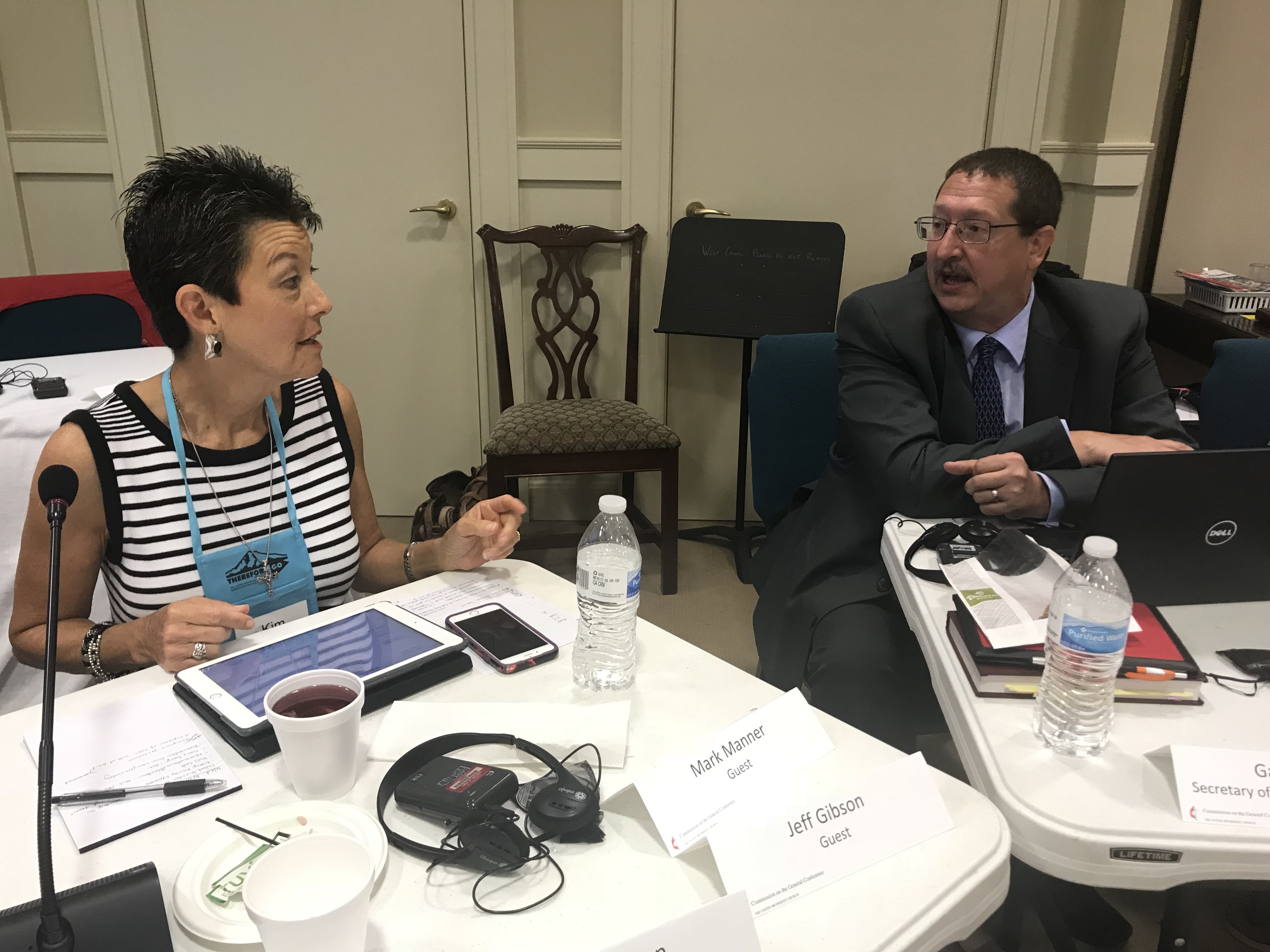 Commission chair Kim Simpson confers with the Rev. Gary Graves, secretary of the General Conference, at a Commission meeting in Lexington, Ky.