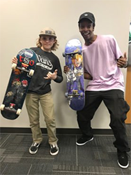 Noah Lusk, 13, left, and Brandon Morrow, 28, study the Bible and enjoy performing skateboard tricks during Skatechurch hosted by First United Methodist Church in downtown Tulsa, Okla. RNS photo by Bobby Ross Jr.