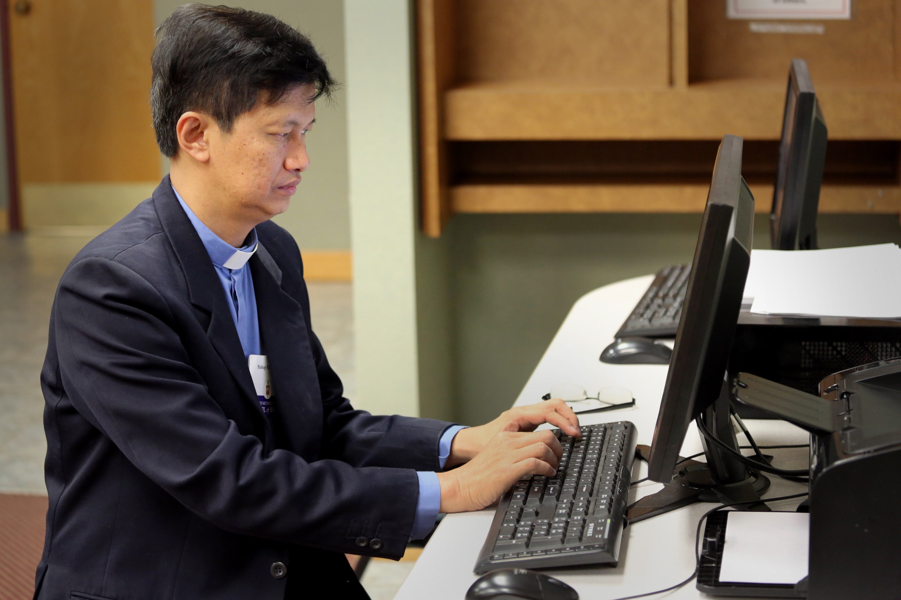 Bishop Pete Torio emails his wife at home in the Philippines during a 2013 Council of Bishops meeting at Lake Junaluska. File photo by Andrew Jensen, United Methodist Communications. 