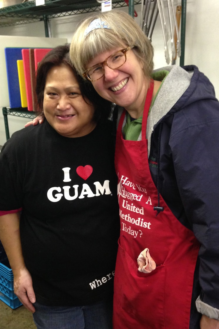 The Rev. Beth Estock (r) and members of Zacc's House volunteer at Potluck in the Park, a program that feeds homeless and low-income folks in Portland under the direction of a volunteer head cook (l). Photo courtesy the Rev. Beth Estock.