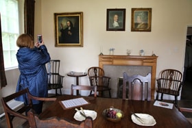 The Wesley family gathered for meals in the dining room of the Old Rectory in Epworth. Portraits of Samuel and Susanna Wesley are mounted above the fireplace, with a portrait of John Wesley to the left. Photo by Kathleen Barry, United Methodist Communications.