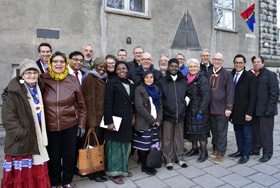Methodists from Norway and international guests gather outside the Methodist Church in Trondheim, Norway, during the 100-year celebration of the first Sami Congress. The center plaque denotes the church as a United Methodist historic site. Photo by Karl Anders Ellingsen.