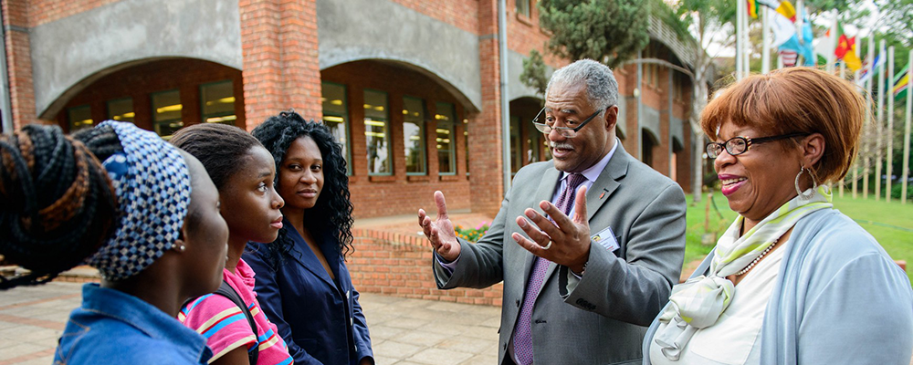 Bishop Julius C. Trimble, chair of the development committee of teh AU Board of Directors stops to talk with AU students.