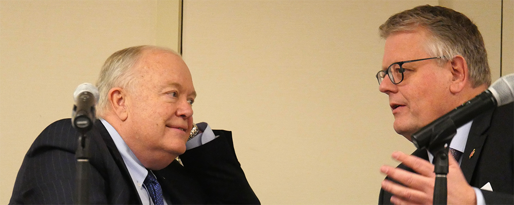 Bishops Mike McKee and Christian Alsted discuss the process for voting on budget proposals during a joint meeting of the General Council on Finance and Administration board and Connectional Table in Nashville, Tenn. McKee is president of the finance agency board and Alsted is chair of the Connectional Table.