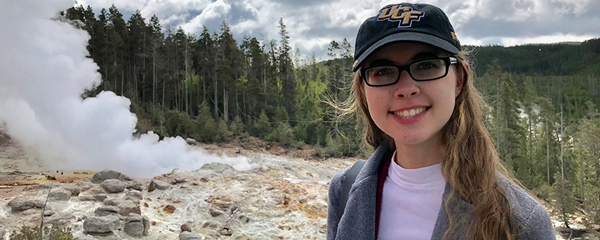 Alyssa Martin poses for photo on mountain top. Alyssa Martin poses for photo on mountain top.