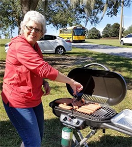 Volunteer of Joining Hands Mission UMC cooks up hotdogs for community event. Courtesy photo.