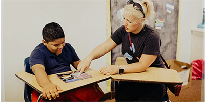 Another volunteer tutoring a youth at the Corner's Academy.