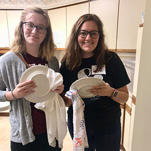 Emma Allen, (left) and friend drying dishes. 