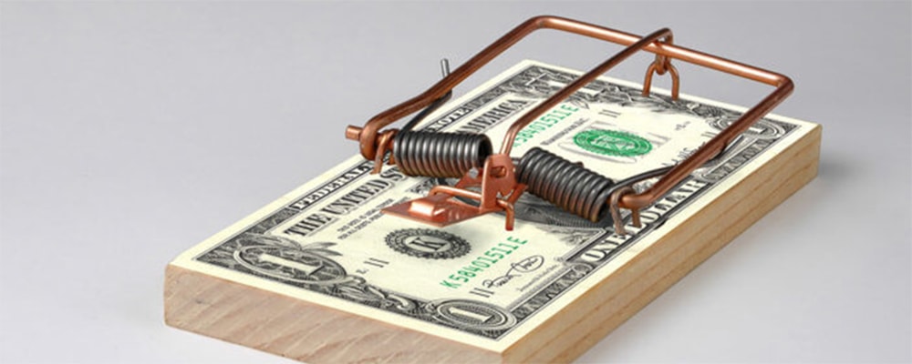 Courtesy/Stock photo. Image of dollar bills in a mousetrap.