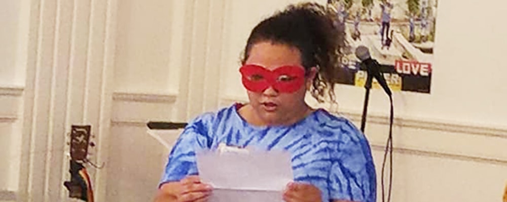 Brittani Fletcher stand at podium during a program at her congregation. Courtesy photo.