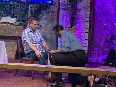 Pastor Herman Perez washes Pastor Charlie Moore's feet during Maundy Thursday worship service. Courtesy photo.