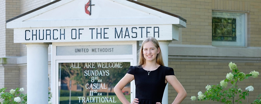 Kaleigh Rudge poses in front of home congregation's marquee. Courtesy photo.