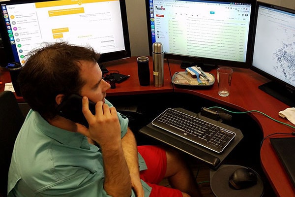 Matthew Marchetti, a member of Chapelwood United Methodist Church in Houston, looks at three computer screens as he works to locate people who need rescuing during Hurricane Harvey. Marchetti, along with fellow Chapelwood member Oliver Carter, came up with a design for a web app, HoustonHarveyRescue.com, to help connect those in need with volunteer rescuers. Photo courtesy of Matthew Marchetti.