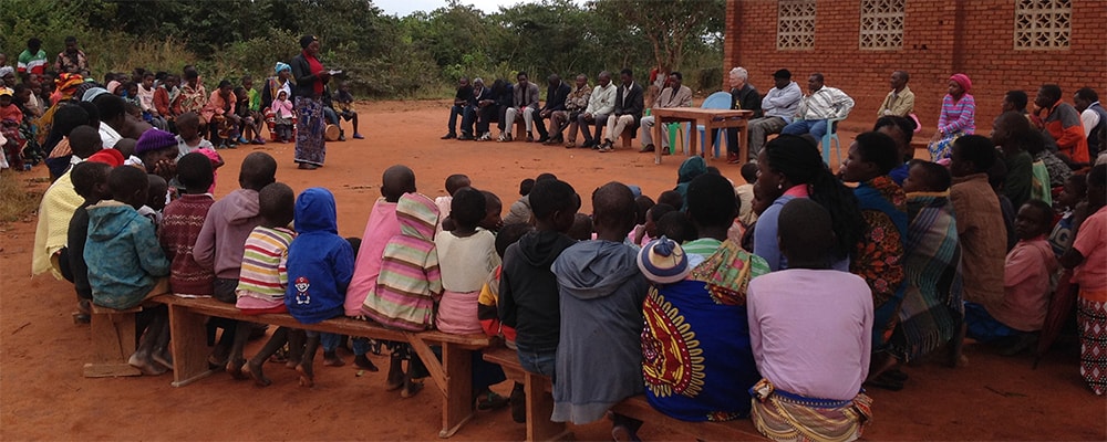 A community awareness meeting in Malawi offers information on what HIV services are available and how to access them. Photo: WorldHope Corps.