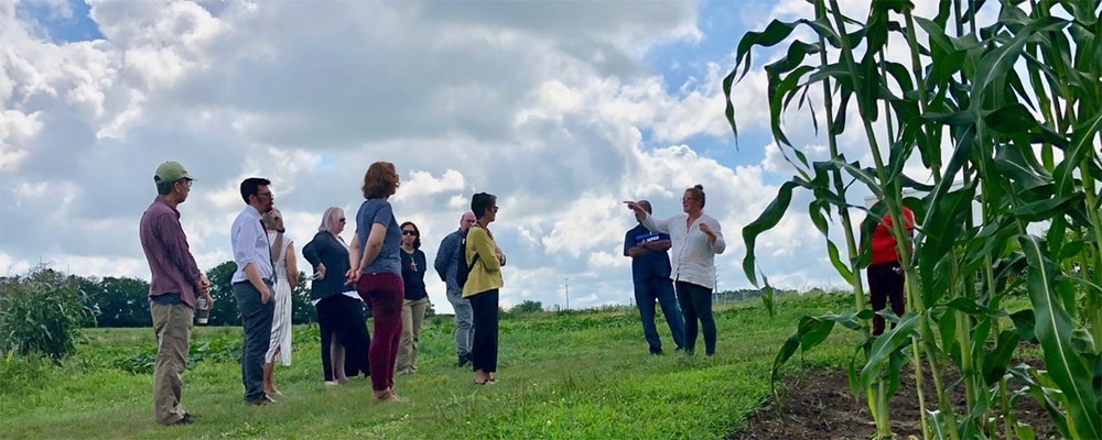 Bishop Dyck and cabinet members talk with local farmers about their struggles. Courtesy photo.
