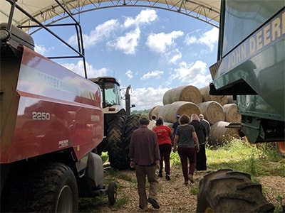Members take a tour of a farm with large equipment. Courtesy photo.