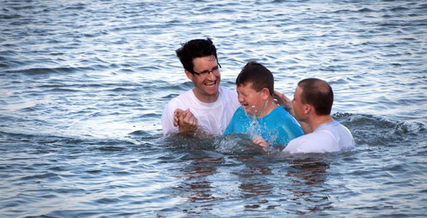Marshall Greene (center) is baptized during the Annual Inlet Baptism in Murrells Inlet off the Belin Memorial United Methodist Church's seawall. Holding him is (left) Austin Bond, director of youth ministries and (right) Walter Cantwell, associate pastor. Photo by Benjamin Coy