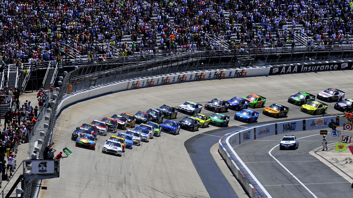 The green flag marking the start of the NASCAR FedEx 400 waves as cars pick up speed prior to crossing the checkered line at Dover International Speedway. Photo by Staff Sgt. Elizabeth Morris, courtesy of the U.S. Air Force.