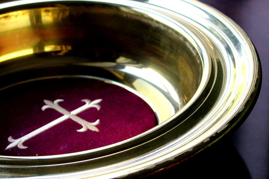 Offering plate featuring cross. Photo by Kathryn Price, United Methodist Communications.