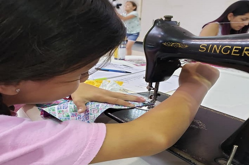 Katie Chapa, 8, is part of the sewing group at La Trinidad United Methodist Church sewing group. Photo by Valerie Mendoza.