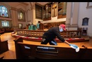 Custodian James Jimmerson disinfects pews to prevent any possible spread of the coronavirus at Belmont United Methodist Church in Nashville, Tenn. on Sunday, May 10, 2020, after online worship, which was recorded in the sanctuary. As churches consider returning to in-person worship, cleaning measures are one of many factors leaders will need to consider. “I believe my job, my part in this, is to make sure people are safe in here,” Jimmerson said. Photo by Mike DuBose, UM News.