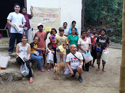 Karl Wesley E. Dillozon (far left) takes group photo some of the clinics patients.