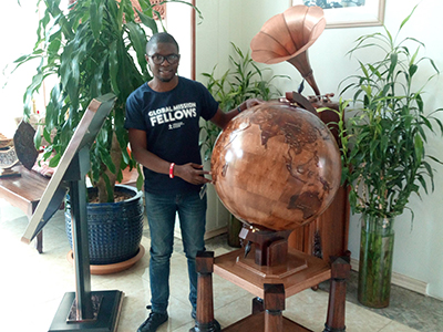 WCS Scholar stands next to Globe. Courtesy photo.