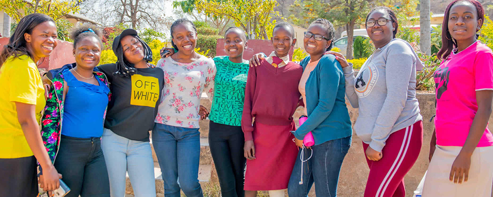 Ben Hill residents pose for a photo with Helen Murinda. Photo credit: Office of Advancement and Public Affairs (OAPA), Africa University.