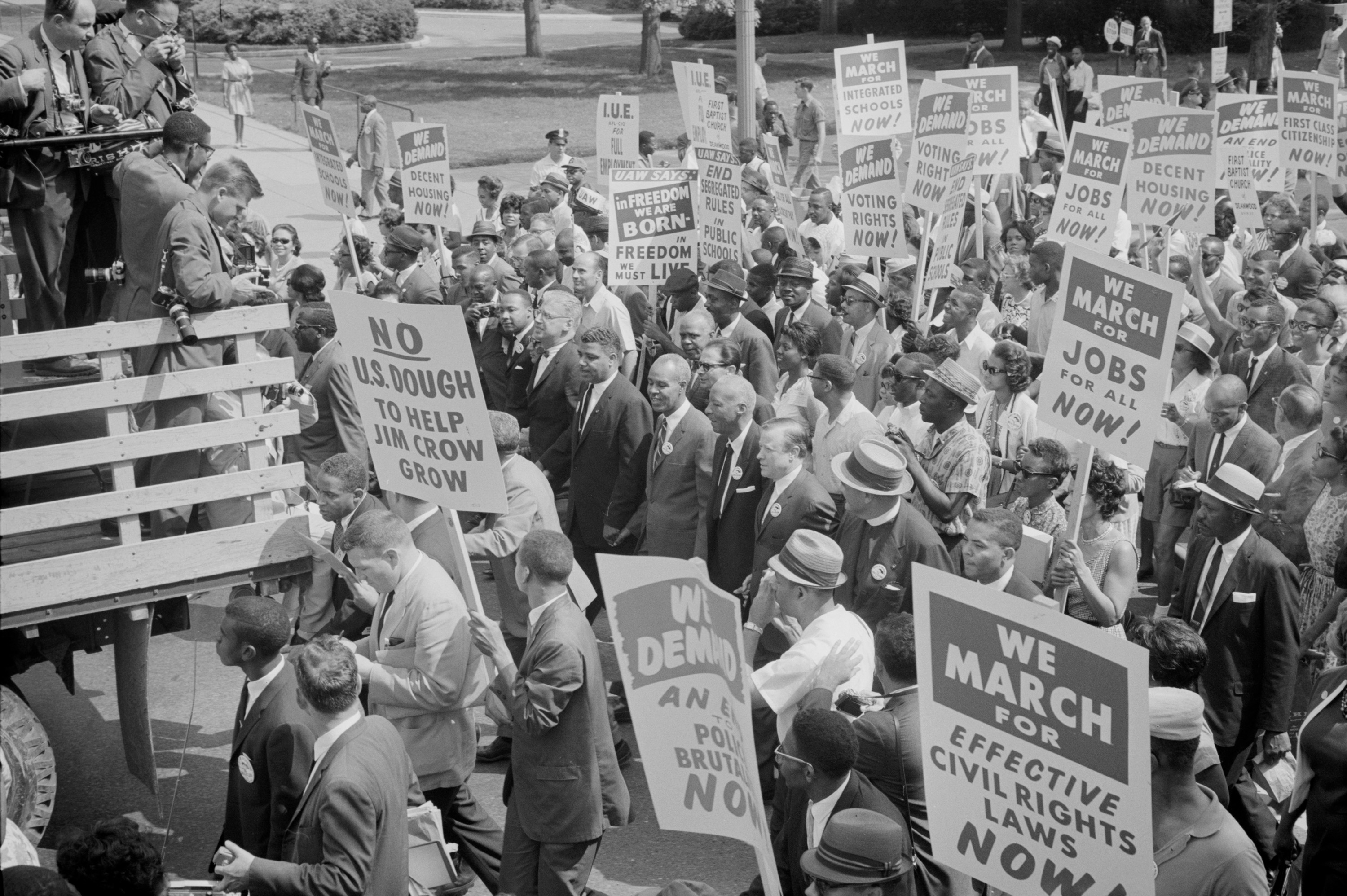 Civil rights leaders, including Martin Luther King, Jr., surrounded by crowds carrying signs at the March on Washington for Jobs and Freedom, August 28, 1963. Photo from the Library of Congress