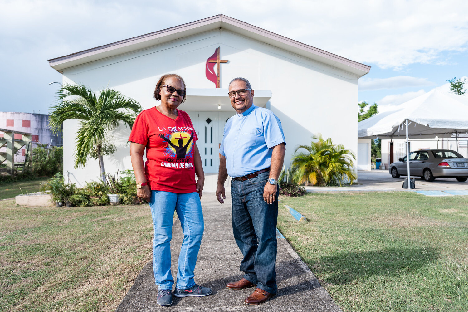 Pastor Hector Florez and Diaconal Minister Gloria Santiago stand in front of the church they serve in Puerto Rico, Iglesia Metodista Mesón de Amor, which became a community lifeline after Hurricane Maria. Photo courtesy of the United Methodist Development Fund.