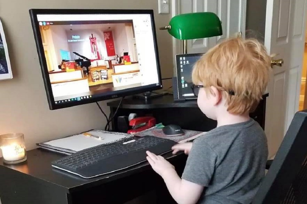 During the coronavirus pandemic, many United Methodist churches are holding online worship services, such as Glendale United Methodist Church in Nashville. Here, a young member of the Glendale UMC family watches. Photo courtesy of Glendale United Methodist Church